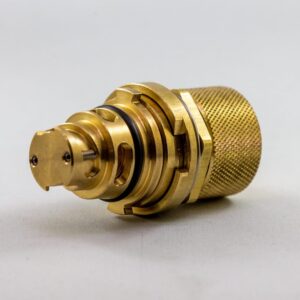 a gold metal object with a round cap Paccar 2023 Plug 2